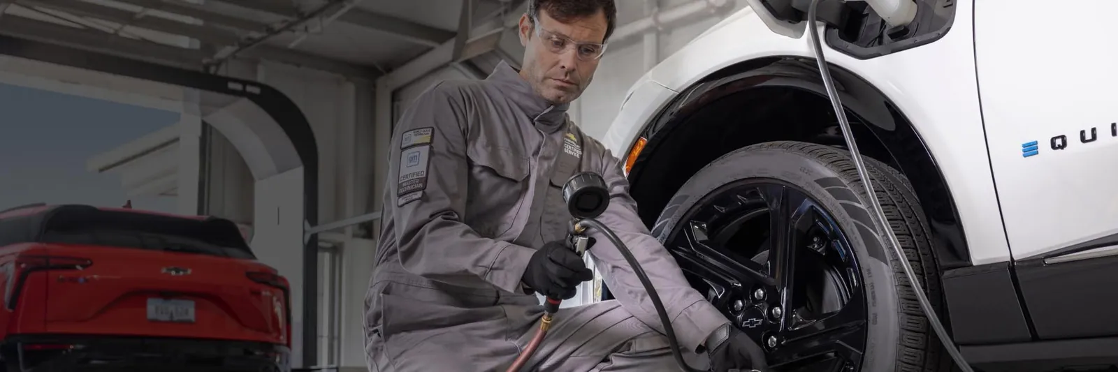 Technician servicing a Chevrolet vehicle in the shop
